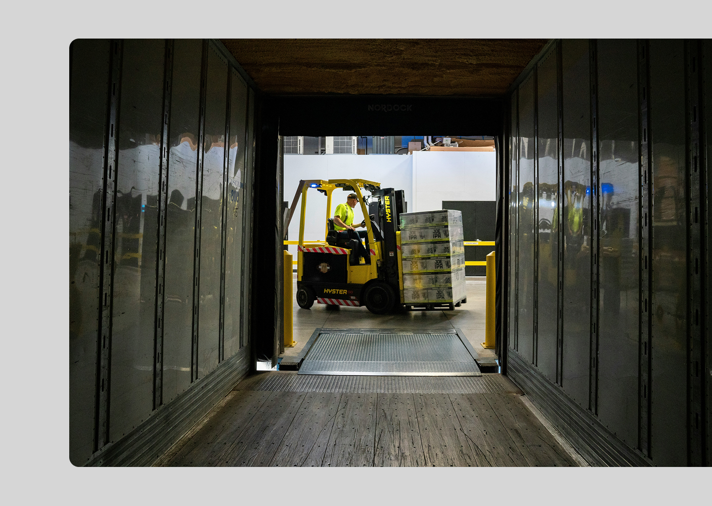 Inbound direct materials being unloaded from a trailer using a forklift.