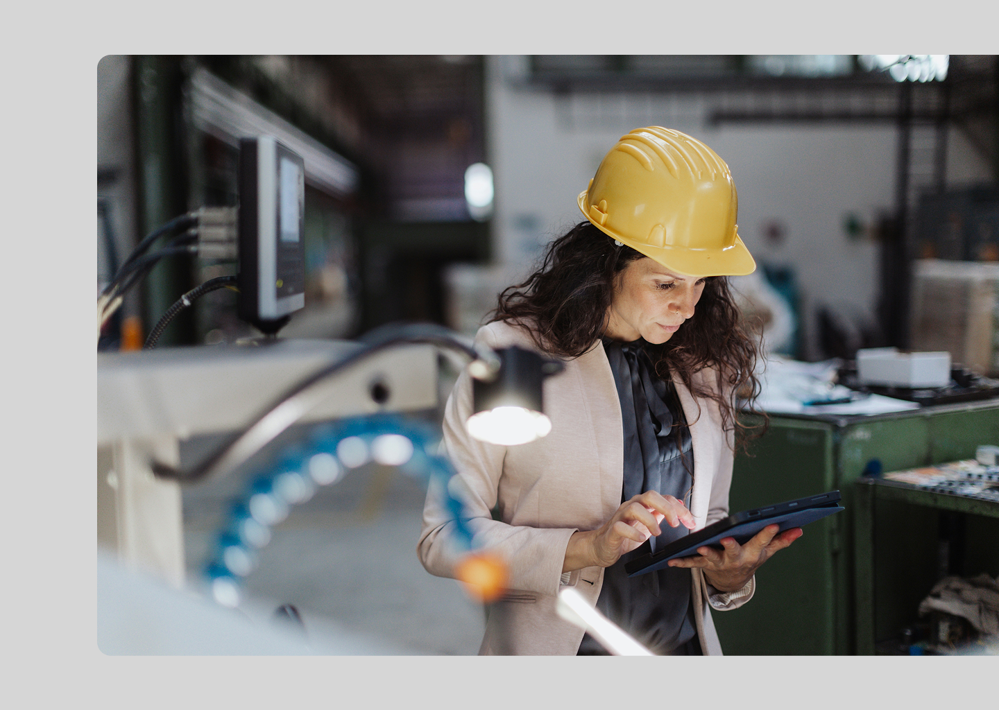 Operations planner on the factory floor uses a tablet to review ERP planning data, supporting real-time decision-making with Nvexus.